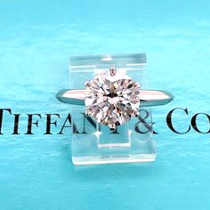 Tiffany & Co Round Diamond Tiffany Setting Engagement Ring Style:  6 Prong Solitaire Ref. number:  26141001 / K04030256 Metal:  Platinum PT950 Size:  6.25  Measurements:  2 mm TCW:  1.85 tcw Main Diamond:  Round Brilliant Diamond  Color & Clarity:  E, VS1 Diamond Crown Inscription:   T&Co.K04030256 Hallmark:  26141004 1.85CT © TIFFANY&CO.PT950 Includes:  T&C Diamond Certificate - T&C Inner & Outer Ring Boxes Retail:  $61,500 Sku#154246TERL042123 Return Policy: Returns accepted up to 14 days. Tiffany Engagement Ring Round Tiffany & Co., Tiffany Setting Engagement Ring, Tiffany Engagement Ring Tiffany & Co., Tiffany Setting Engagement Ring Tiffany & Co., Luxury Jewelry Diamond Tiffany & Co., Diamond Pendant Tiffany & Co., Tiffany Setting, Setting Engagement Ring, Engagement Ring Pictures