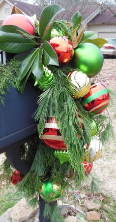 a christmas wreath on top of a mailbox