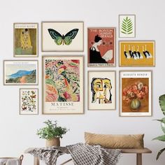 there are many different pictures on the wall in this room with a bench and potted plant