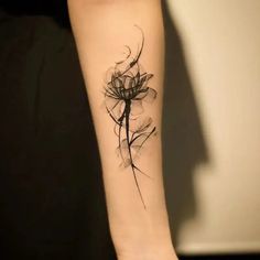 a woman's arm with a flower tattoo on it