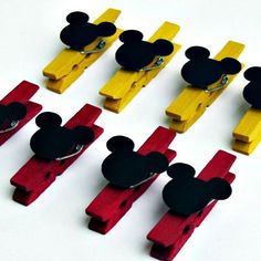 several mickey mouse magnets are placed on top of each other in different colors and shapes