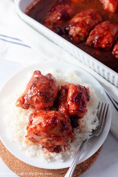 the meatballs are covered in sauce on top of white rice and is ready to be eaten