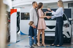 a family buying a car at a dealership