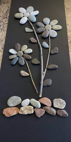 a black mat topped with stones and a tree branch