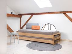 a bed sitting on top of a wooden frame in a bedroom