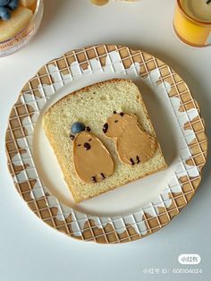 a piece of bread with peanut butter and jelly bears on it sitting on a plate