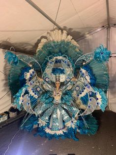 an elaborate blue and white bird decoration in a tent