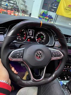 the interior of a car with steering wheel and gauges on display in a showroom