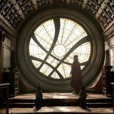 a man standing in front of a stained glass window on top of a set of stairs