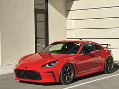 a red sports car parked in front of a building