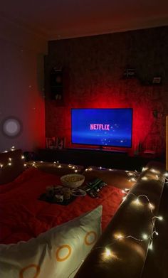 a room that has some lights on the floor and a television in the wall behind it