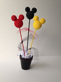 three mickey mouse cake toppers in a black pot