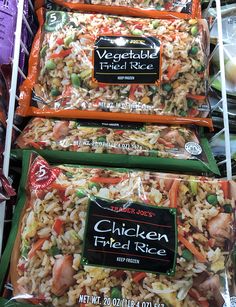 three packages of chicken fried rice are on the shelves in a grocery store, ready to be sold