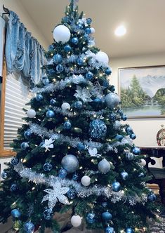 a blue and white christmas tree with snowflakes