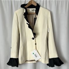 Beautiful Vintage Nwt Martin Martin Ivory/Black Blazer Jacket Coat. Size 36 = Us Size 6. Made In France Dry Cleaning Only Materials: 73% Acetate, 27% Viscose Built In Shoulder Pads Beautiful Ruffle Detailing On Sleeves, Neckline, And Down Front Measurements: Armpit To Armpit: 17” Shoulder Length: 16” Sleeve Length: 25” (Including Ruffles) Entire Length: 26.5” Disclaimer: Tiny Pinholes On Upper Front, As Pictured **Comes From A Clean, Smoke Free Home** Black Blazer, Jacket Coat, Shoulder Length, Shoulder Pads, Blazer Suit, Made In France, Blazer Jacket, Ruffles, Suit Jacket