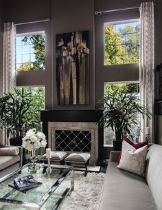 a living room with two couches and a coffee table in front of the fireplace