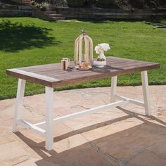 a wooden table sitting on top of a stone patio