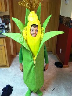 a young boy in a costume made to look like a corn cob