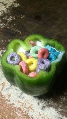 a green pepper filled with cereal sitting on top of a counter