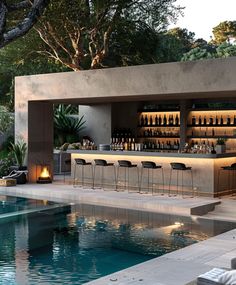 an outdoor bar next to a swimming pool