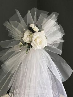 a white veil with flowers on top of it