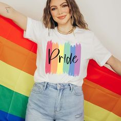 The "Pride Paint Strokes" Graphic Tee is more than just a garment; it's a vibrant celebration of diversity, love, and unity within the LGBTQ+ community. Crafted with meticulous attention to detail, this tee combines comfort with style, making it the perfect choice for expressing your pride and solidarity. The colorful rainbow paint strokes create a bold and eye-catching design, symbolizing the spectrum of identities and experiences within the LGBTQ+ community. Whether you're marching in a pride Relaxed Fit Crew Neck T-shirt For Pride, Cotton T-shirt With Rainbow Print For Pride, White Pre-shrunk Top For Pride, Trendy Crew Neck T-shirt For Pride, Trendy Rainbow Pride T-shirt, Rainbow Print Graphic Tee For Pride, Graphic Tee With Rainbow Print For Pride, Trendy Rainbow T-shirt For Pride, Trendy Multicolor Pride T-shirt