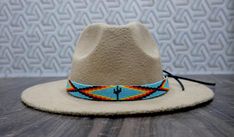 100 % Leather Hat-band is Hand Beaded with intricate beaded patterns by skilled Artisans Inspired by Native American crafting techniques and Indian beaded jewelry Beaded portion about 19.0 inches, handmade products, dimensions may slightly vary. Adjustable ties in the back. Hypoallergenic - Made with non-reactive Materials 100 percent Natural Environment friendly materials. Handcrafted with tiny Cubic Zirconia Seed Beads with beautiful and detailed beadwork. Western Style Adjustable Beaded Jewelry, Artisan Hand-stitched Adjustable Jewelry, Artisan Beaded Adjustable Hats, Handmade Multicolor Southwestern Hats, Handmade Southwestern Multicolor Hats, Hand-stitched Adjustable Bohemian Jewelry, Handmade Southwestern Multicolor Hat Band, Bohemian Handmade Hat Bands For Gift, Bohemian Beaded Adjustable Hat Bands