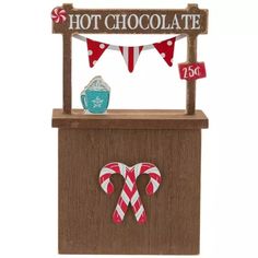 a hot chocolate stand with candy canes on it