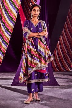 Purple kurta with marodi and zardozi embroidery in a circular shape. Comes with straight pants and stripe print dupatta.
Component: 3
Pattern: Print and Embroidery
Type Of Work: Stripe Print, Marodi and Zardozi
Neckline: V neck
Sleeve Type: Three Quarter
Fabric: Banarasi Silk and Organza Silk
Color: Purple
Other Details: 
Embroidered neckline and hem
Side slits
Stripe print dupatta with embroidered border
Occasion: Wedding - Aza Fashions Punit Balana, Zardozi Embroidery, Kurta Pant Set, Print Embroidery, Embroidered Border, Embroidered Neckline, Kurta With Pants, Silk Organza, Pant Set