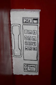 a drawing of a phone on a red wall