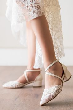 the bride's shoes are all white and have lace on them