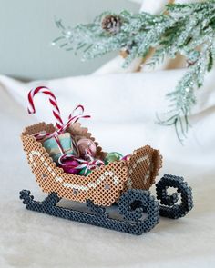 a small toy sleigh filled with candy canes