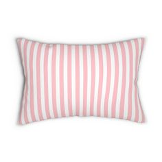 a pink and white striped pillow on a white background