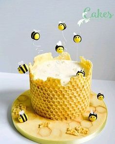 the cake is decorated with bees and icing