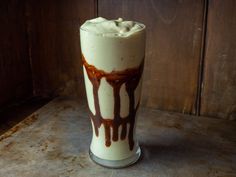 a tall glass filled with ice cream and chocolate