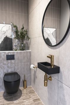 a bathroom with a sink, mirror and toilet paper dispenser in it