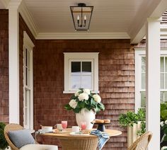 a table and chairs on the front porch