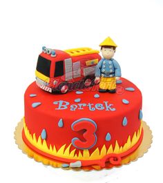 a birthday cake with a firetruck on top and number 3 in the middle