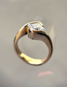 a gold ring with a diamond on it