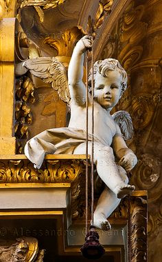 a statue of an angel on top of a building