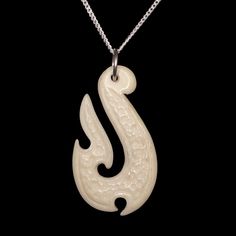 Hand carved bone Maori fishing hook Hei Matau pendant necklace with sterling silver chain The Hei Matau is carved in the shape of a stylized fishhook.  It represents strength, prosperity, fertility, good luck and safe travel over water. It's meaning originated from the Maori legend of Maui who once caught a great fish using only a woven line and hook made from the jawbone of his grandmother. Size: Pendant width: 0.9" (2.2 cm) Pendant height: 1.5" (3.8 cm) Chain length: option 1: 16.5" (42 cm) op Maori Legends, Gifts For Sailors, Sea Lover, Bone Pendant, Fishing Hook, Bone Carving, Fish Hook, Maui, Sterling Silver Chains