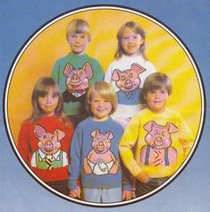 a group of children wearing sweaters with pigs on them in front of a blue background