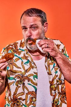 a man with a beard is eating some food