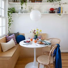 a white table and some chairs in a room