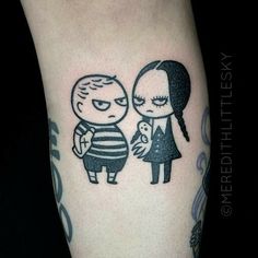 a cartoon tattoo on the leg of a man and woman with an evil looking face