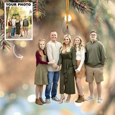 a family posing for a christmas card with their photo hanging from the tree in front of them