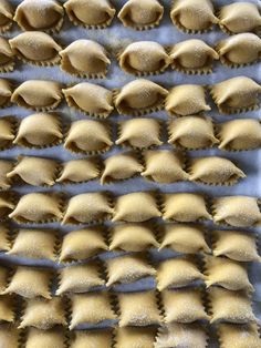 several uncooked ravioli on a baking sheet