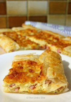 two slices of ham and cheese quiche on a white plate