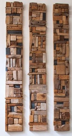 three pieces of art made out of wooden planks are hanging on the wall next to each other