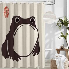 a shower curtain with a brown frog on it's side and chinese characters in the background